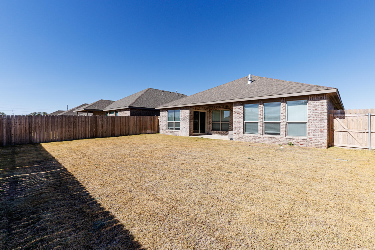7205 25th Street Lubbock, TX 79407 - Photo 48 of 50 a front view of a house with a yard