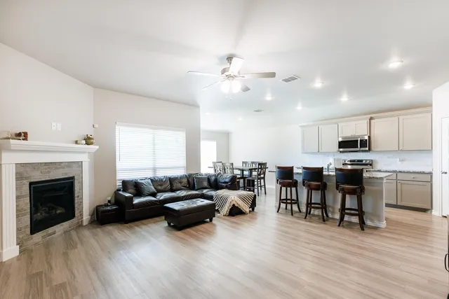 a living room with furniture kitchen view and a fireplace