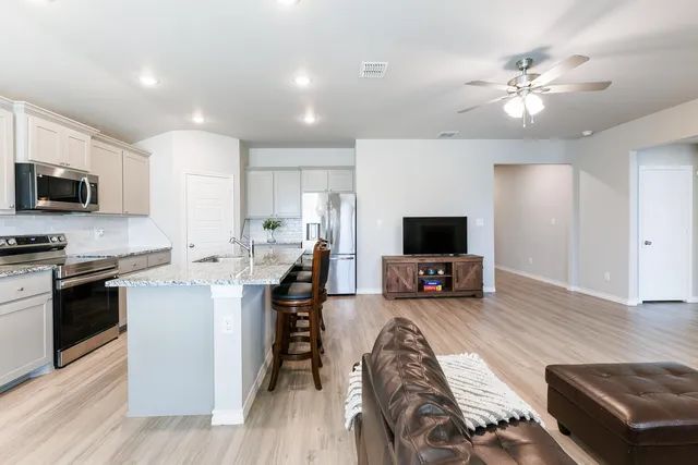 a living room with furniture and a flat screen tv