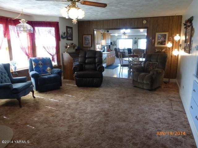 1640 Division Road Zillah, WA 98953 - Photo 11 of 49 a living room with furniture and a chandelier