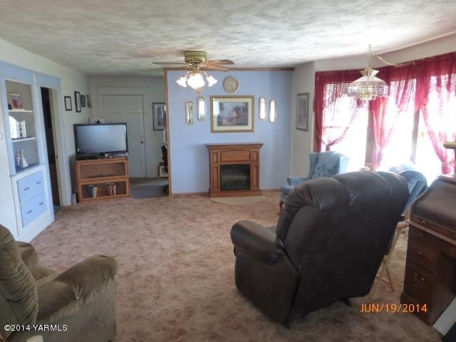 1640 Division Road Zillah, WA 98953 - Photo 12 of 49 a living room with furniture and a fireplace