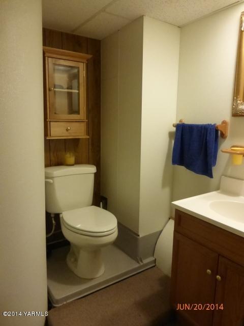 1640 Division Road Zillah, WA 98953 - Photo 19 of 49 a white toilet sitting next to a bathroom sink