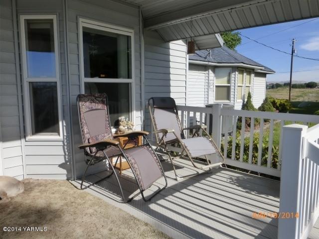 1640 Division Road Zillah, WA 98953 - Photo 3 of 49 a view of a patio with table and chairs with wooden floor