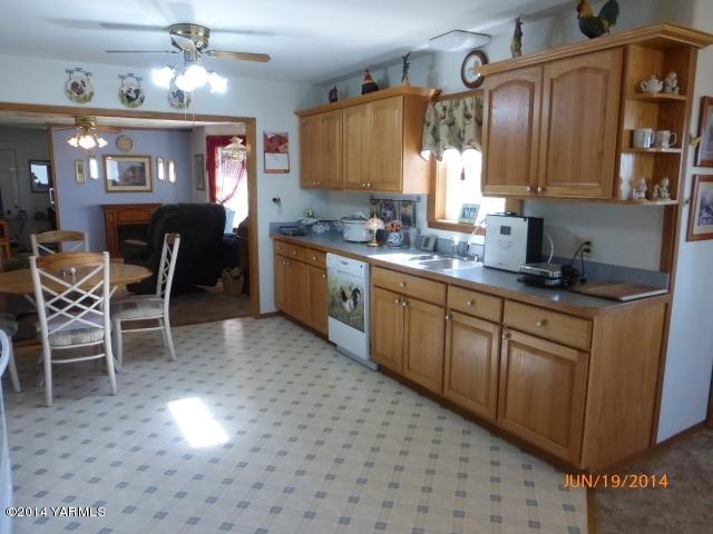 1640 Division Road Zillah, WA 98953 - Photo 9 of 49 a kitchen with stainless steel appliances granite countertop a sink counter space and cabinets