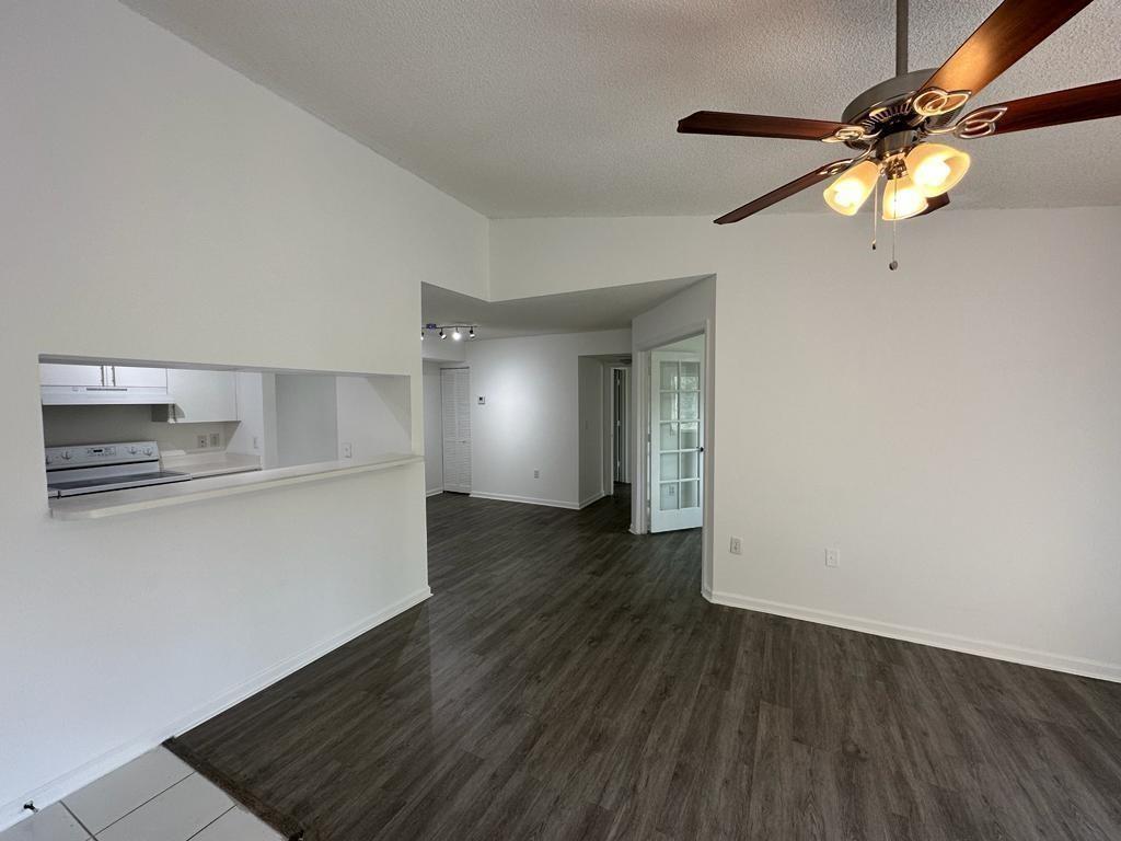 4844 North State Road 7, Unit 305 Pompano Beach, FL 33067 - Photo 14 of 23 wooden floor in an empty room