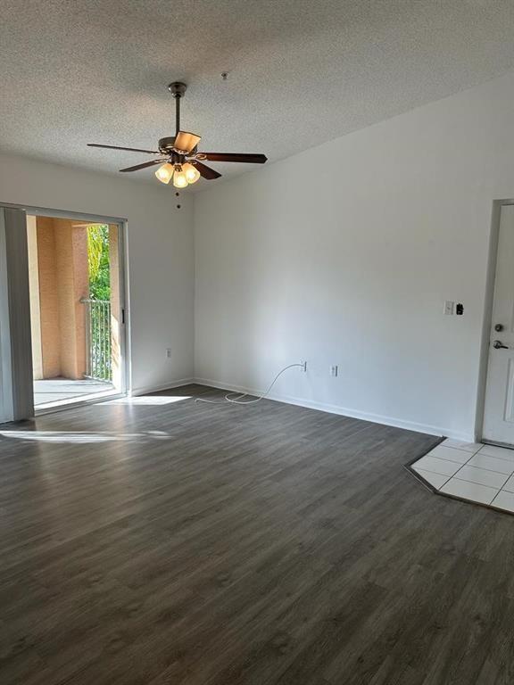 4844 North State Road 7, Unit 305 Pompano Beach, FL 33067 - Photo 15 of 23 wooden floor in an empty room with a window