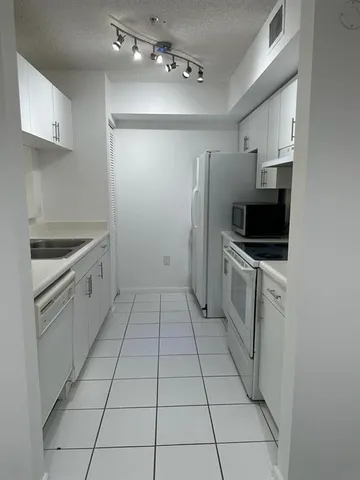 a spacious bathroom with a double vanity sink toilet mirror and bathtub