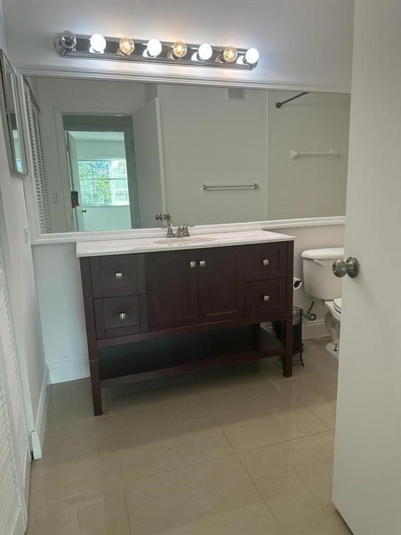 4844 North State Road 7, Unit 305 Pompano Beach, FL 33067 - Photo 21 of 23 a bathroom with a sink vanity and mirror