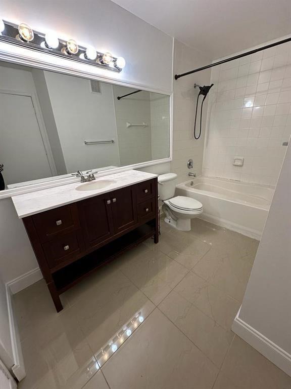 4844 North State Road 7, Unit 305 Pompano Beach, FL 33067 - Photo 22 of 23 a spacious bathroom with a double vanity sink toilet mirror and bathtub