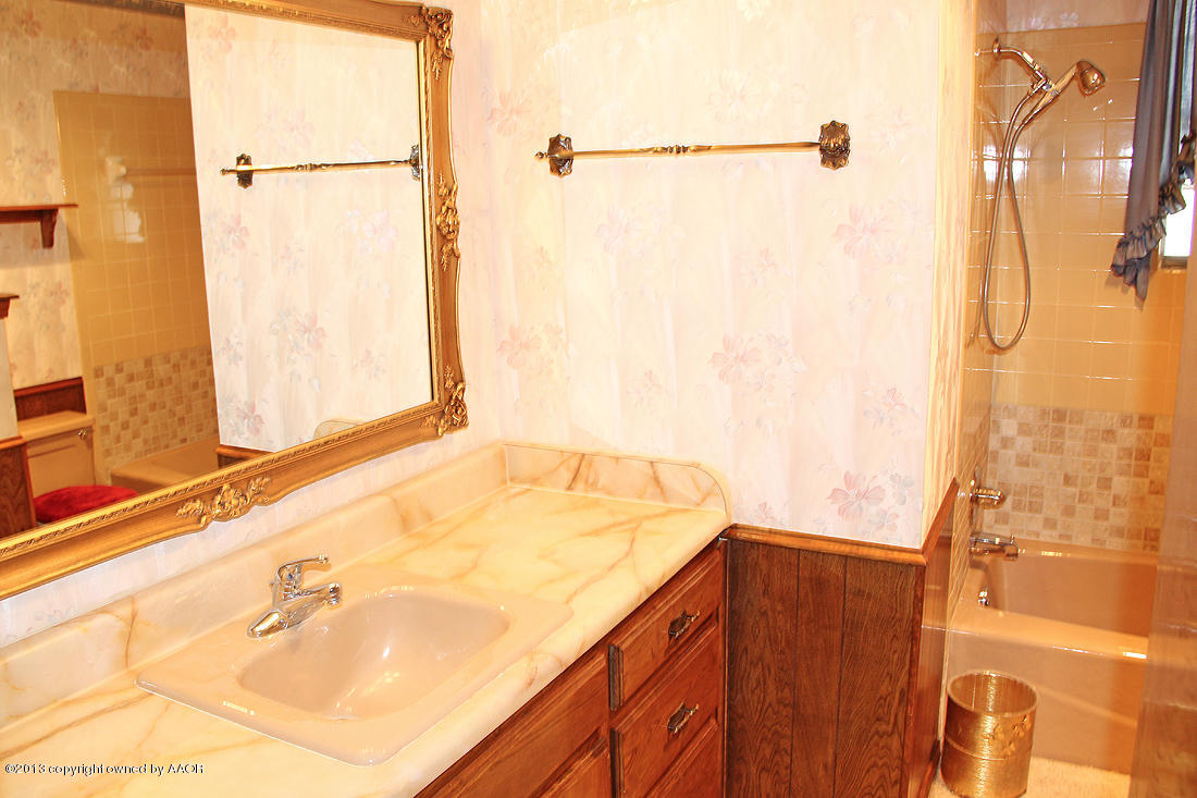 7103 Hatton Road Amarillo, TX 79110 - Photo 15 of 28 a bathroom with a granite countertop sink and a shower