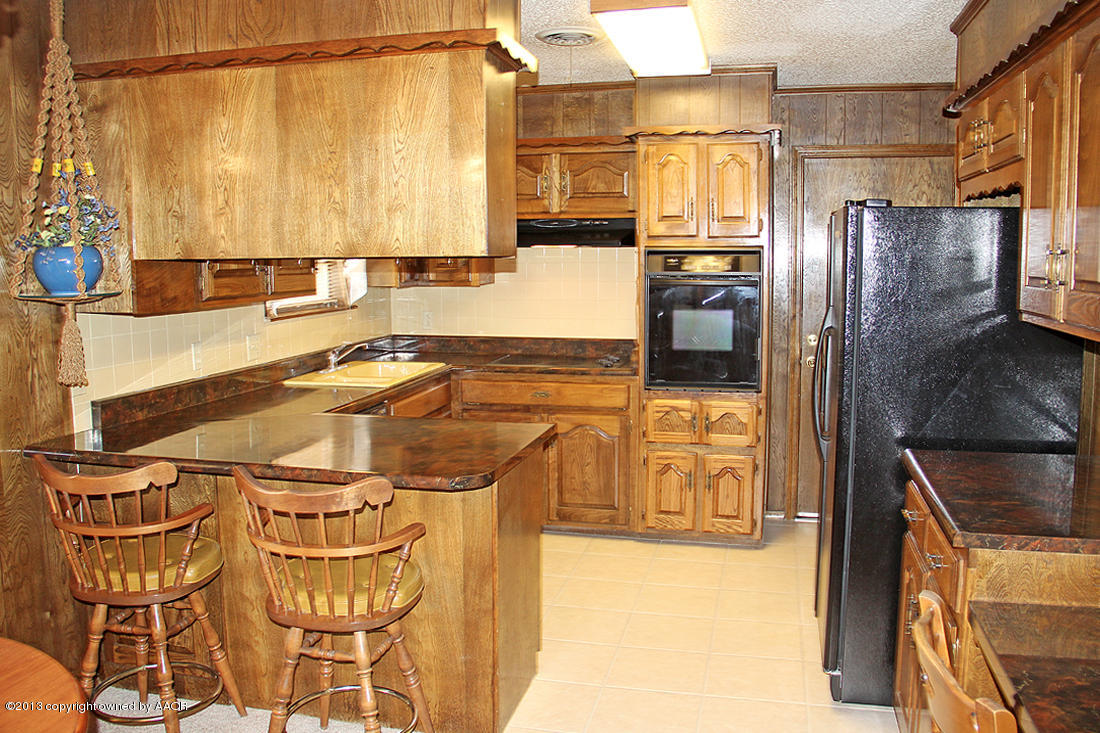 7103 Hatton Road Amarillo, TX 79110 - Photo 21 of 28 a kitchen with stainless steel appliances granite countertop a refrigerator and a stove
