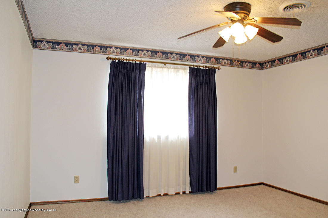 7103 Hatton Road Amarillo, TX 79110 - Photo 5 of 28 a view of a room with a chandelier fan and windows