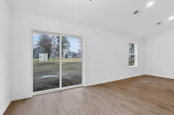 a view of a kitchen with stainless steel appliances kitchen island a large counter top and sink