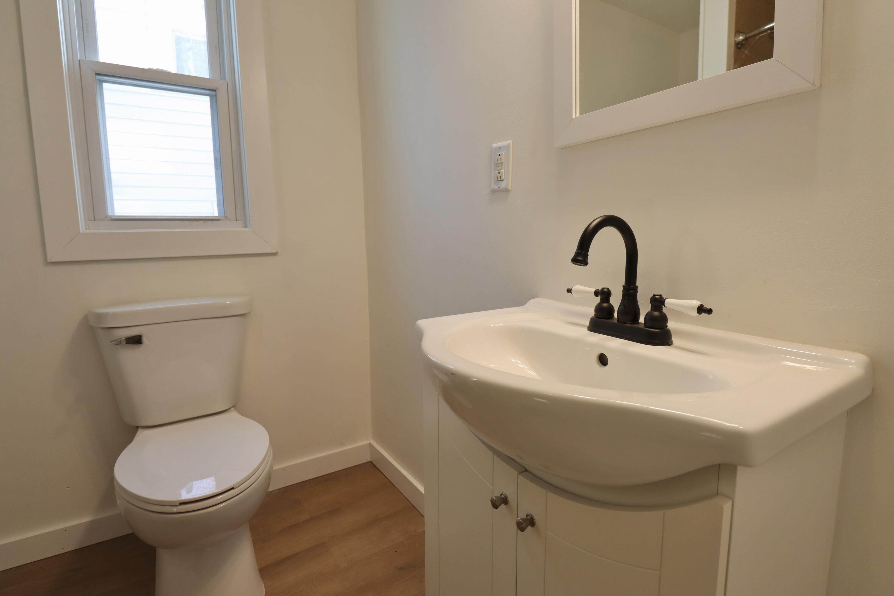 117 Patton Street La Porte, IN 46350 - Photo 19 of 45 a bathroom with a toilet sink and mirror