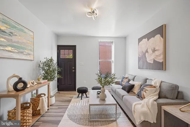 a living room with furniture a couch and a window