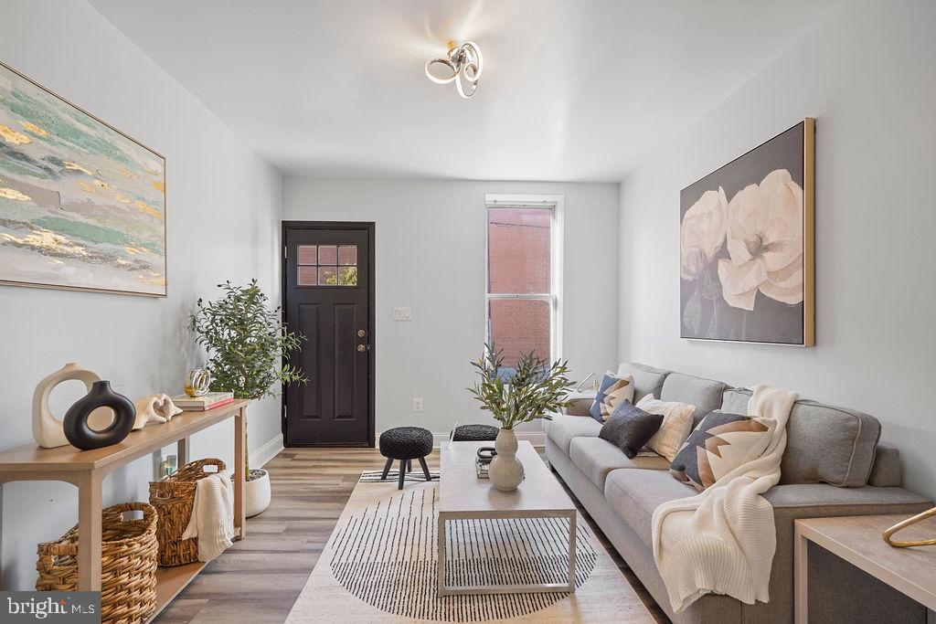 a living room with furniture a couch and a window