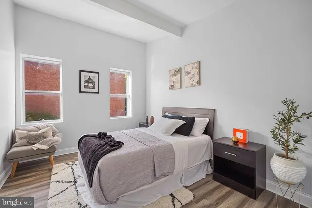 a bedroom with a bed window and a lamp