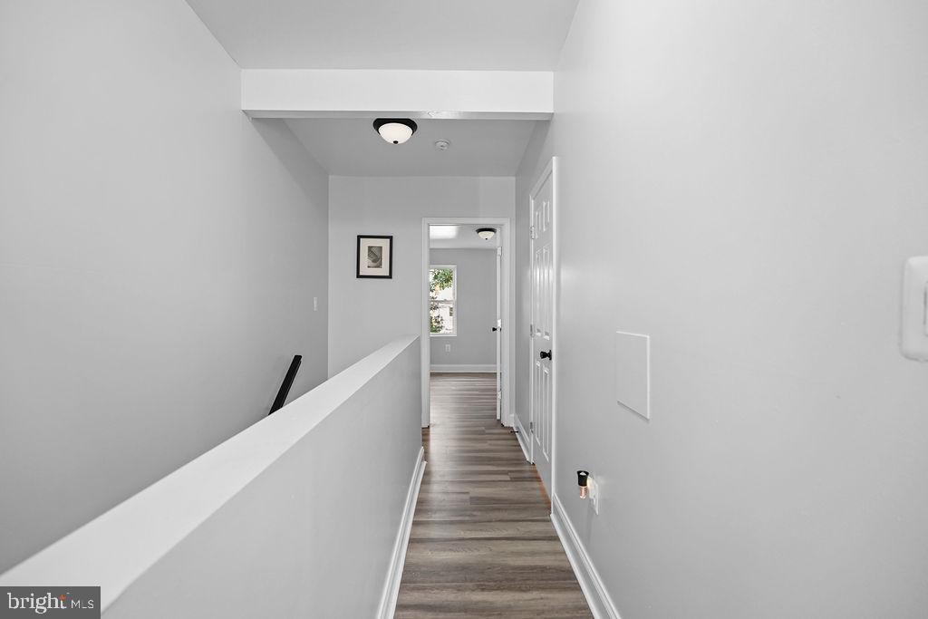 1337 Ward Street Baltimore, MD 21230 - Photo 15 of 17 a view of a hallway with wooden floor and staircase