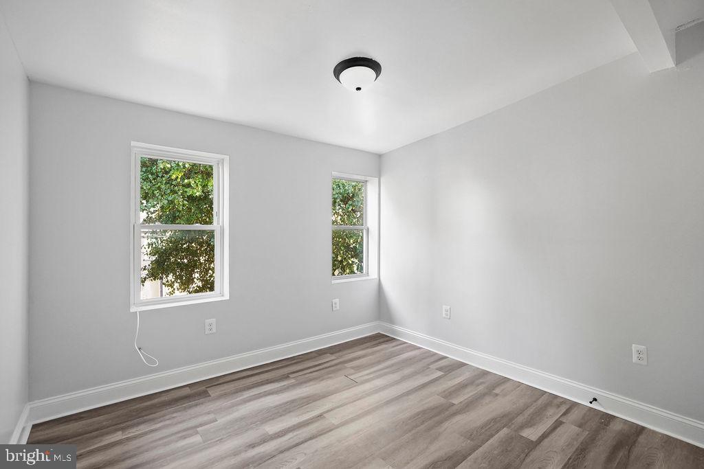 1337 Ward Street Baltimore, MD 21230 - Photo 16 of 17 wooden floor in an empty room with a window