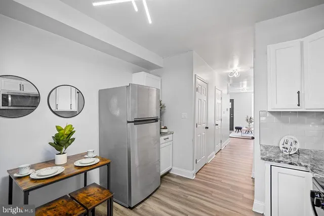 a kitchen with stainless steel appliances granite countertop a refrigerator and a stove top oven