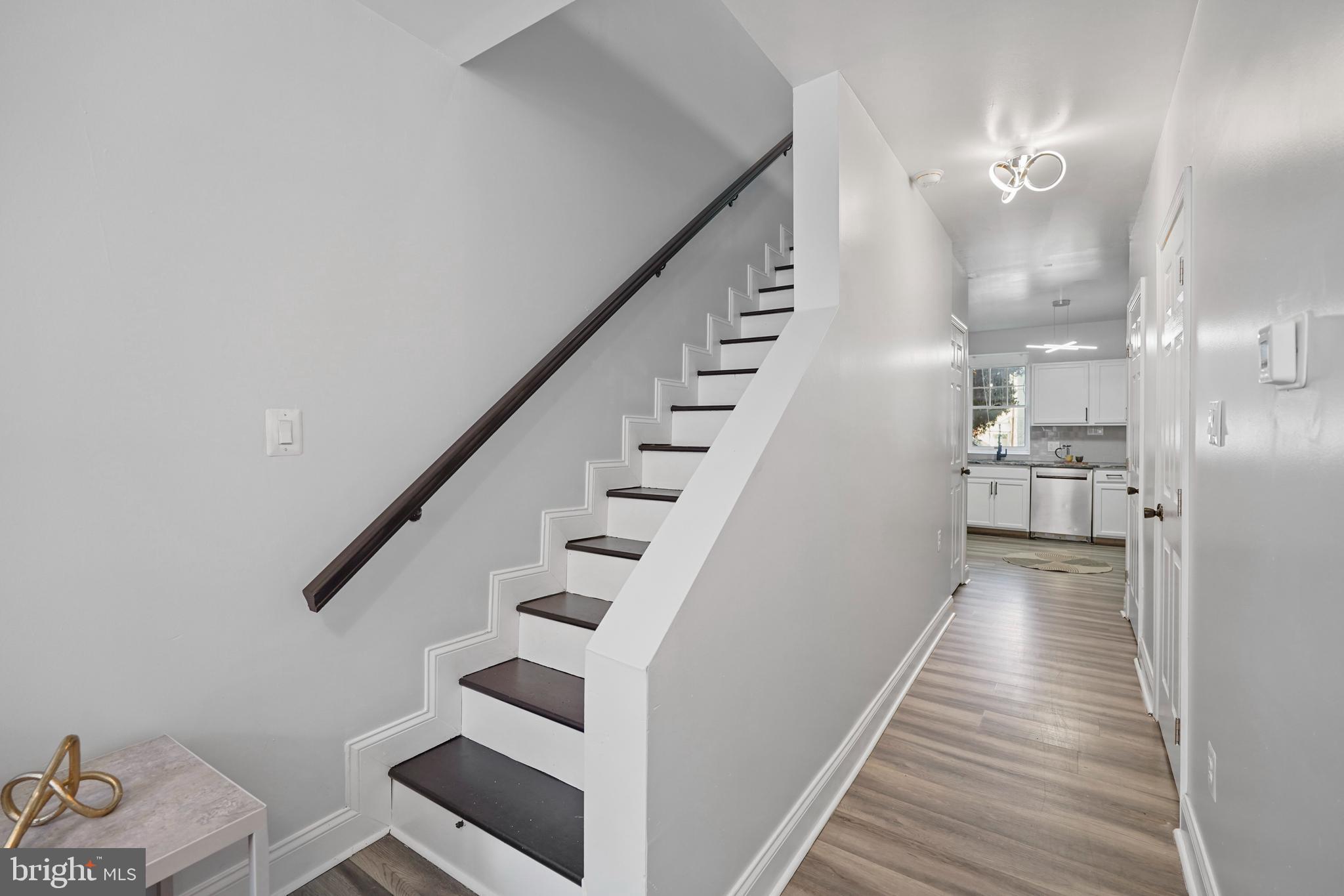 1337 Ward Street Baltimore, MD 21230 - Photo 8 of 17 a view of a hallway with wooden floor and staircase