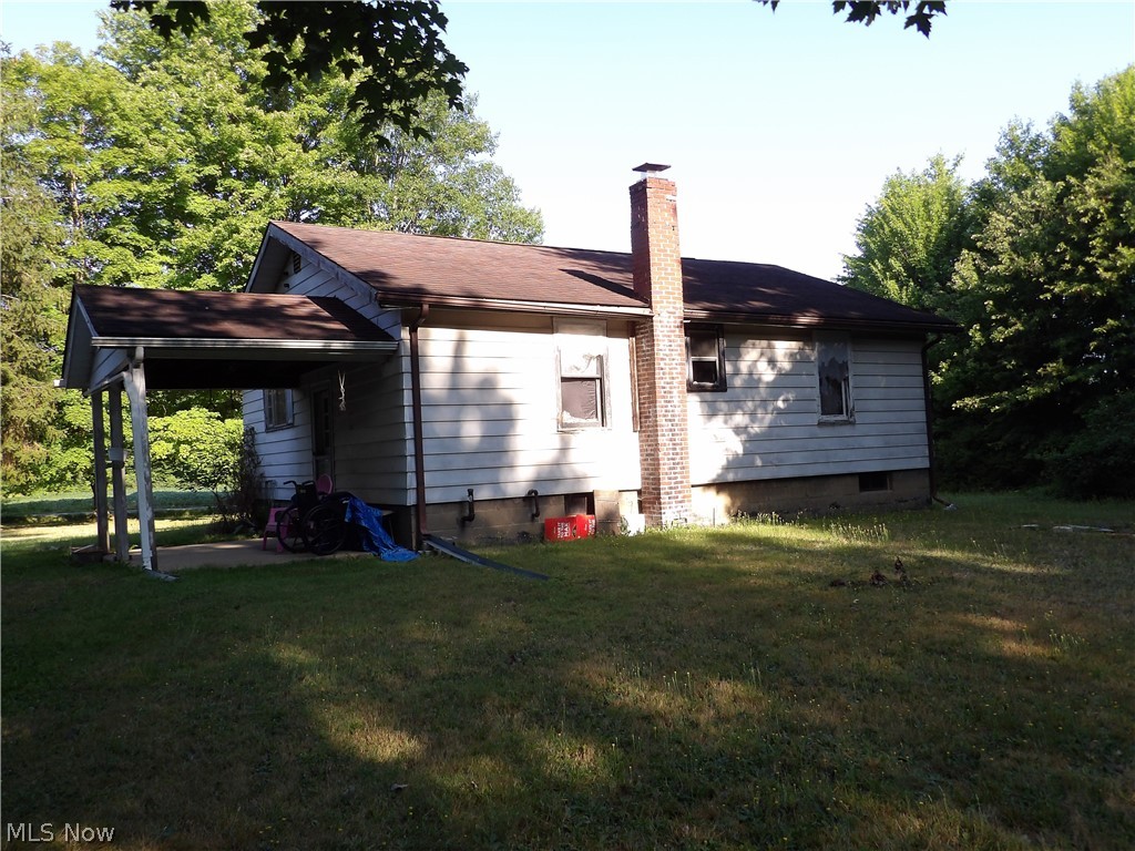 Back of house with a lawn