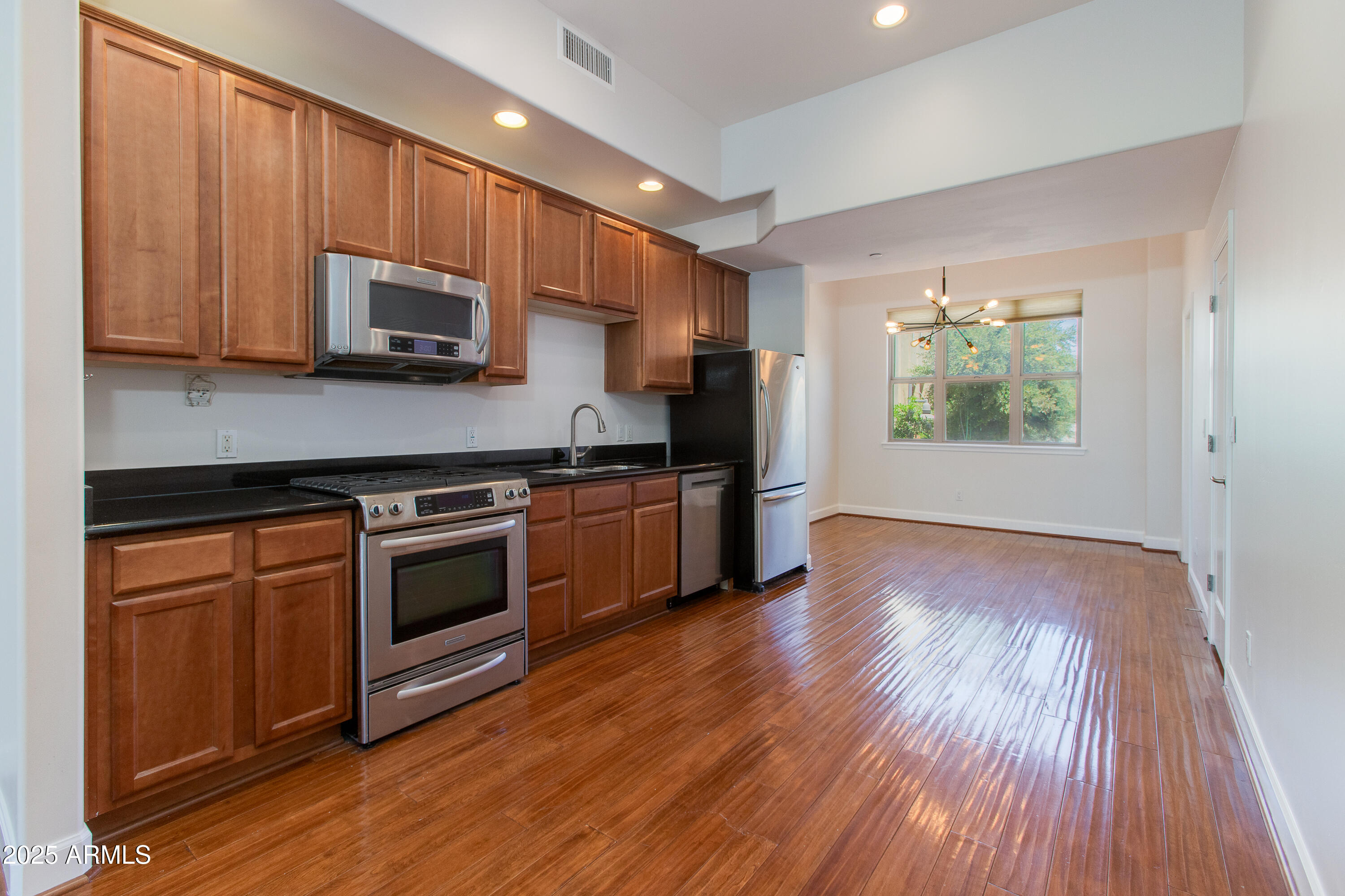 581 South Roosevelt Street Tempe, AZ 85281 - Photo 3 of 14 a kitchen with stainless steel appliances a stove a microwave and sink