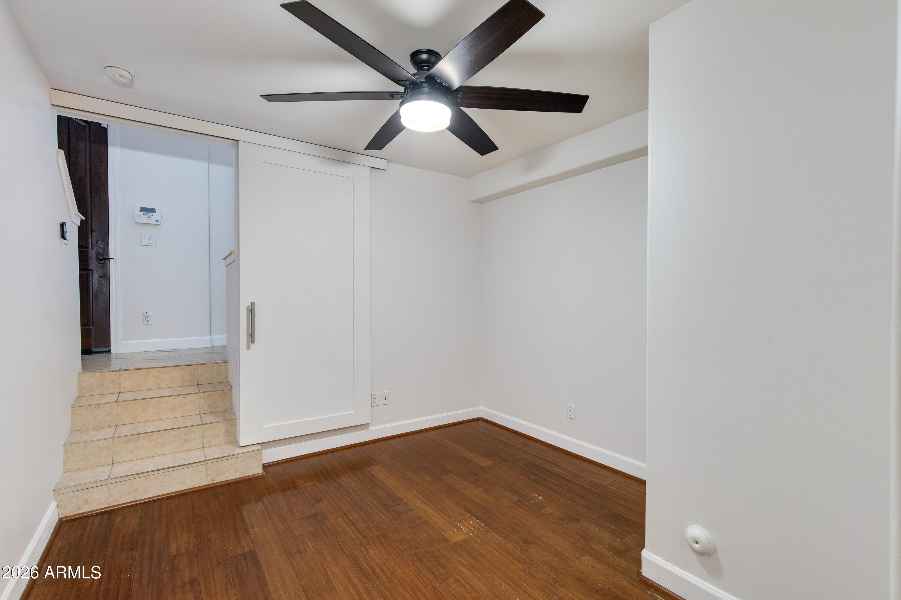 581 South Roosevelt Street Tempe, AZ 85281 - Photo 6 of 14 an empty room with wooden floor and a ceiling fan
