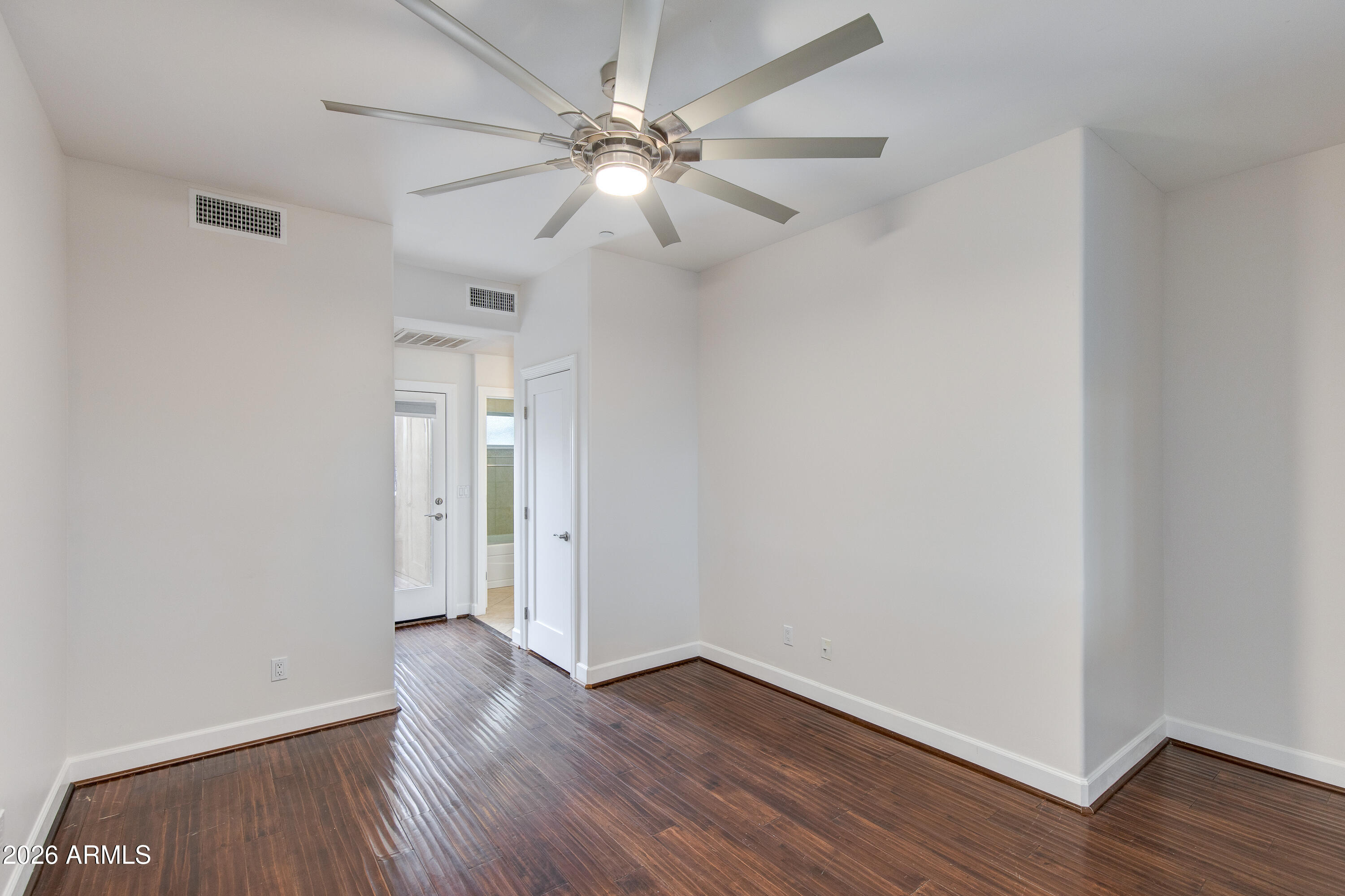 581 South Roosevelt Street Tempe, AZ 85281 - Photo 8 of 14 an empty room with wooden floor and door
