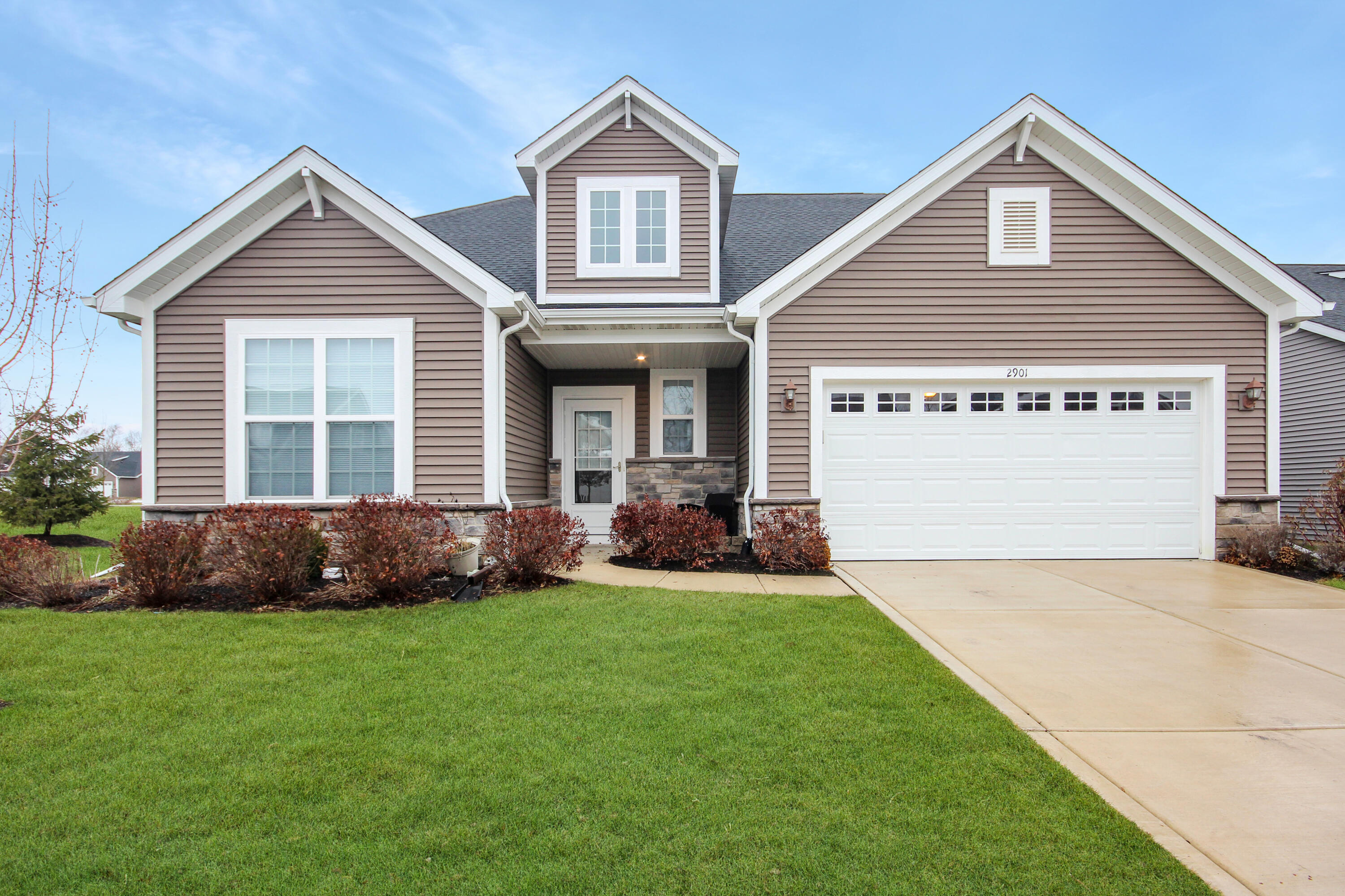 a view of house with yard and green space