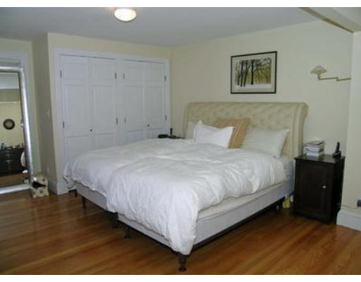88 Williston Road Brookline, MA 02445 - Photo 14 of 22 a large bed sitting in a bedroom next to a bathroom