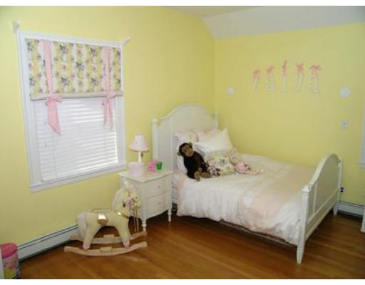 88 Williston Road Brookline, MA 02445 - Photo 15 of 22 a bed sitting in a bedroom next to a window