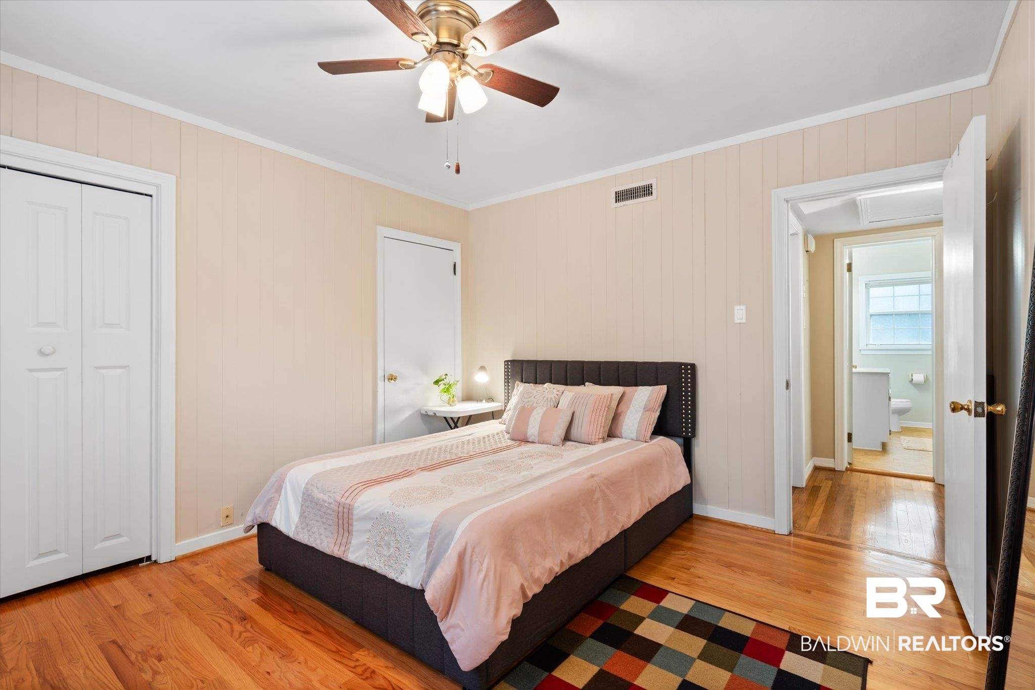 162 Bit And Spur Terrace Mobile, AL 36608 - Photo 13 of 29 Bedroom featuring a closet, ornamental molding, light wood-type flooring, and ceiling fan