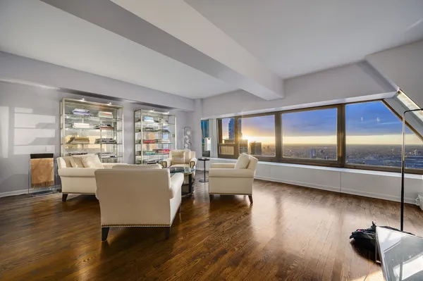 a living room with couches and a coffee table with wooden floor