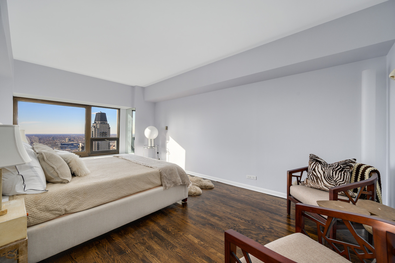 175 East Delaware Place, Unit 46254601 Chicago, IL 60611 - Photo 21 of 33 a bedroom with a bed and wooden floor