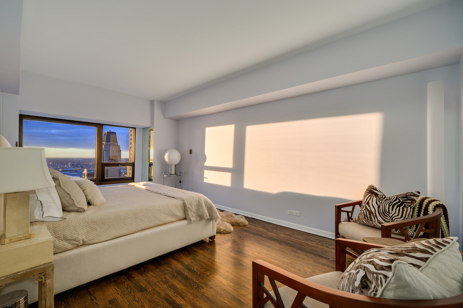 175 East Delaware Place, Unit 46254601 Chicago, IL 60611 - Photo 22 of 33 a bedroom with a bed and wooden floor