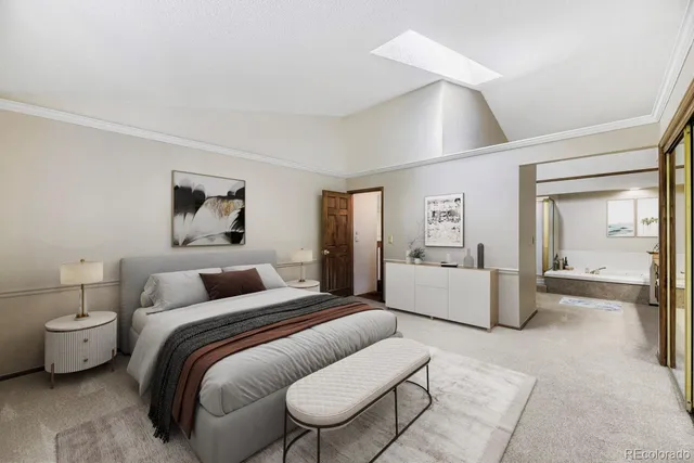 a spacious bedroom with a bed and glass walk in closet