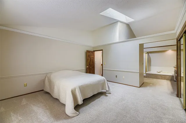 a spacious bedroom with a bed and a cabinets