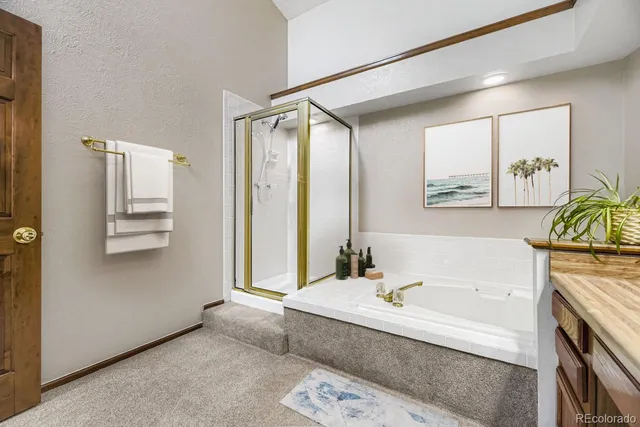 a spacious bathroom with a tub shower and mirror