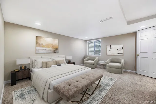 a bedroom with two beds and painting on the wall