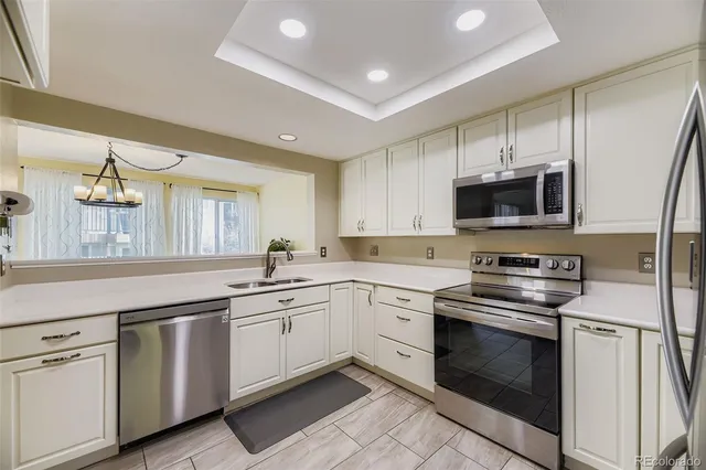 a kitchen with appliances a sink and cabinets
