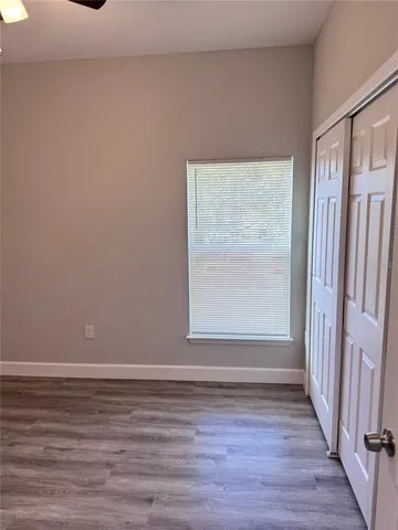 a view of a small space with wooden floor and a window