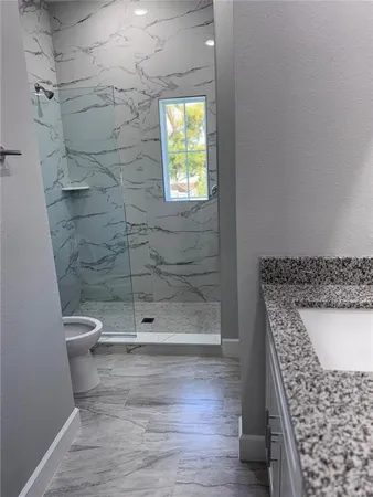 a bathroom with a shower and a toilet