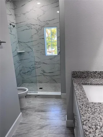 a bathroom with a shower and a toilet