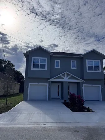 a front view of a house with a yard and garage