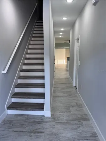 a view of entryway and hall with wooden floor