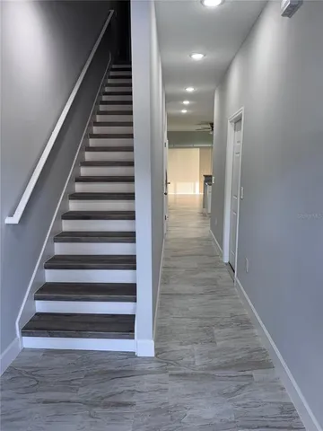a view of entryway and hall with wooden floor