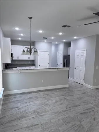 a view of kitchen with refrigerator and window