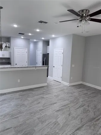 a view of a kitchen with a sink and cabinets