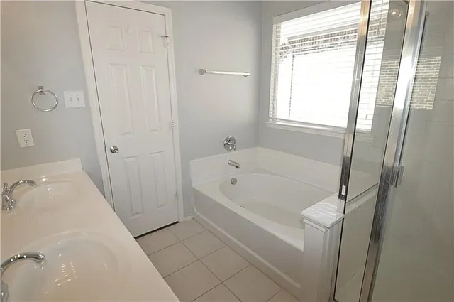 an empty room with a window and a ceiling fan